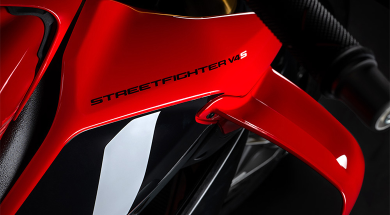 Ducati- Aleron-SF-v4 Detalle del logotipo impreso Streetfighter V4 S en el carenado lateral rojo de una motocicleta Ducati.
